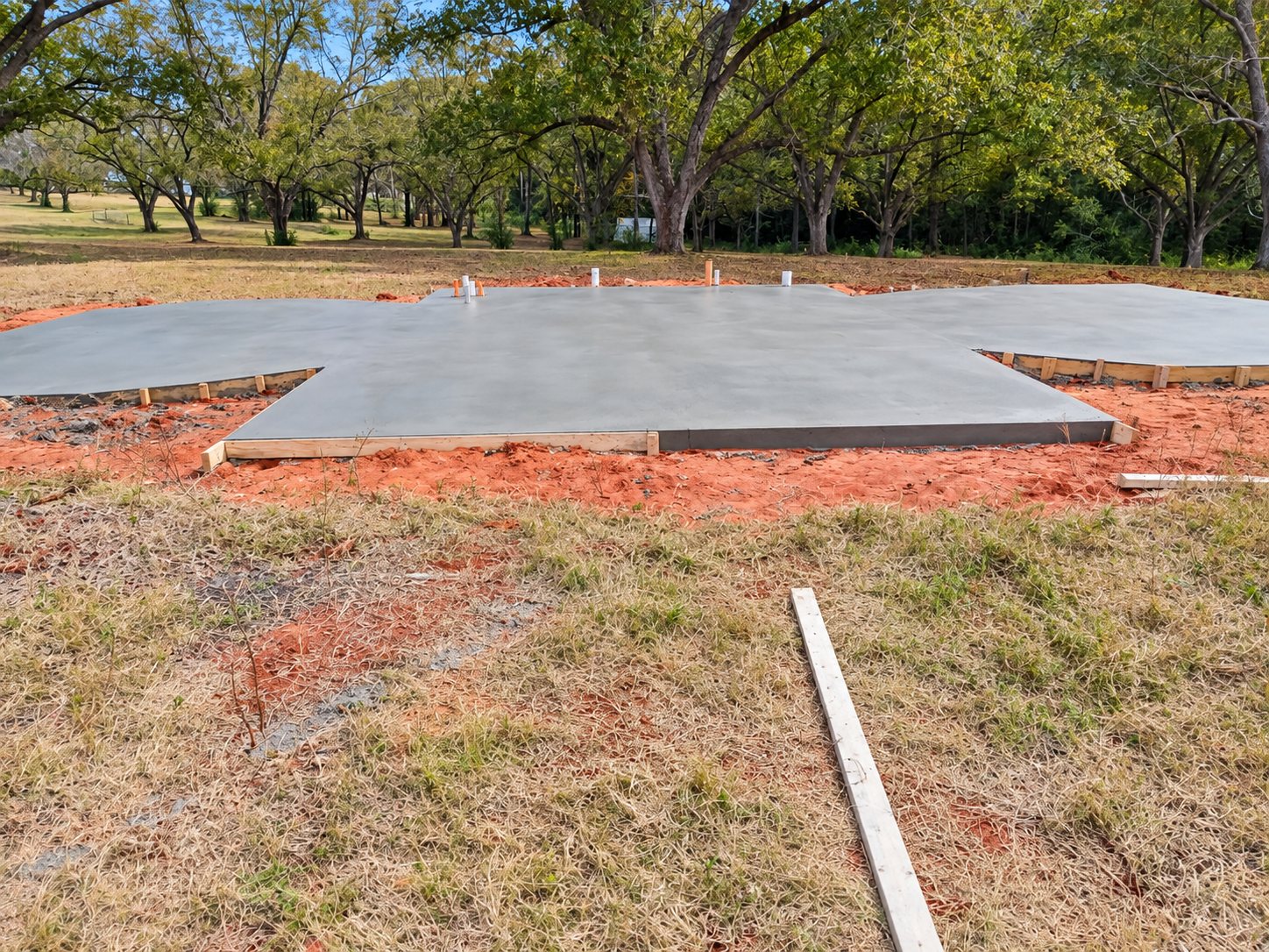Freshly poured concrete slab on a cleared lot