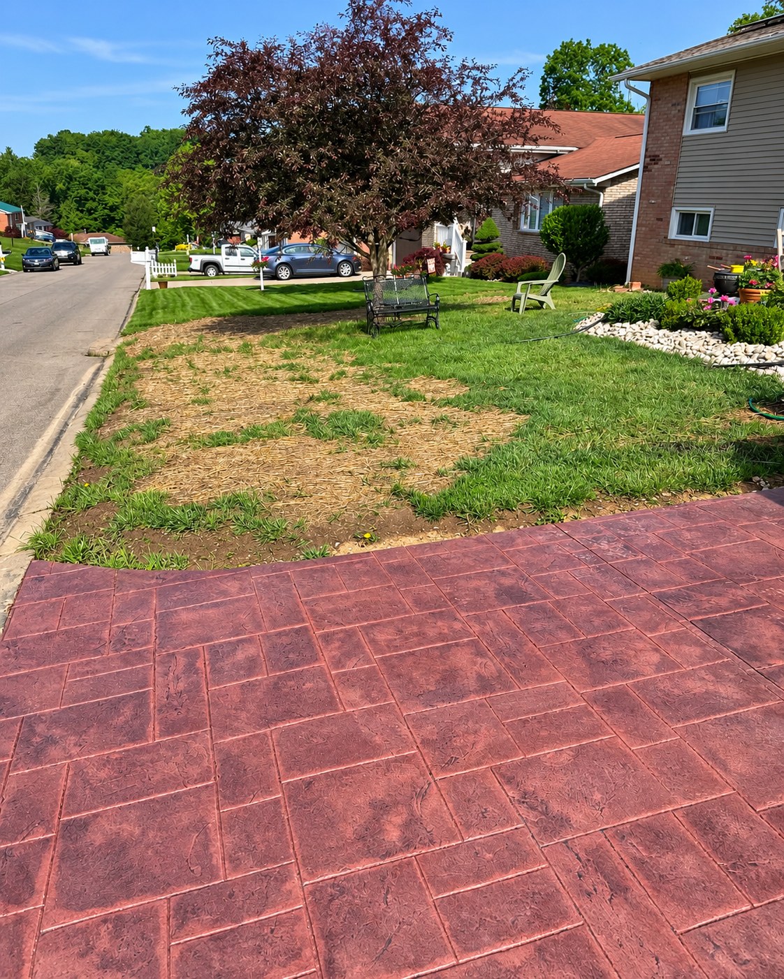 Red stamped concrete in front of a house